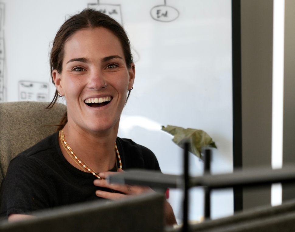 Annie, a Kaura team member, smiling while seated at a desk.